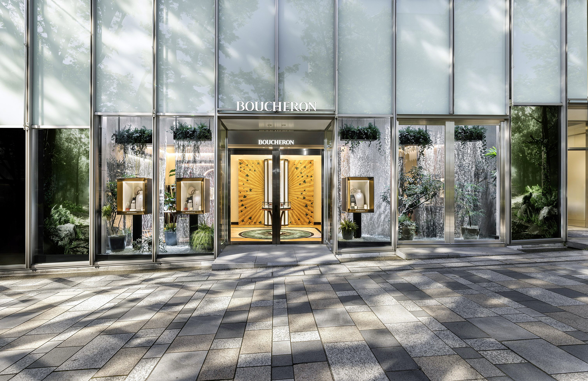 Les vitrines de la boutique Boucheron de Omotesando Hills habillées de végétations et de deux grands écrans.